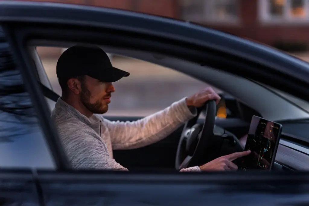 Man In Gray Long Sleeve Shirt Driving Car