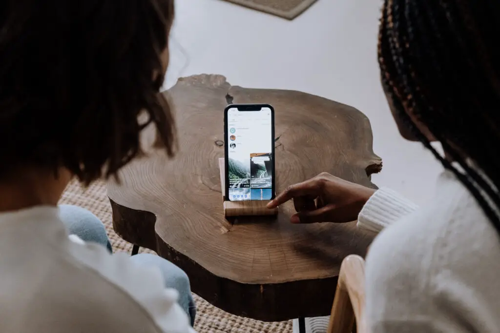 Woman In White Long Sleeve Shirt Holding Silver Iphone 6